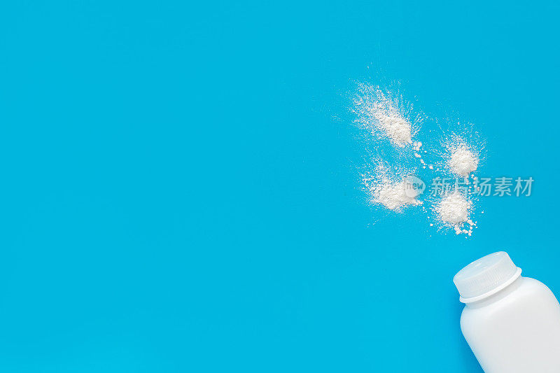 Jar with baby powder from diaper rash on a blue background, flatley, top view, copy space for text, mockup. Baby hygiene, background for newborn boys